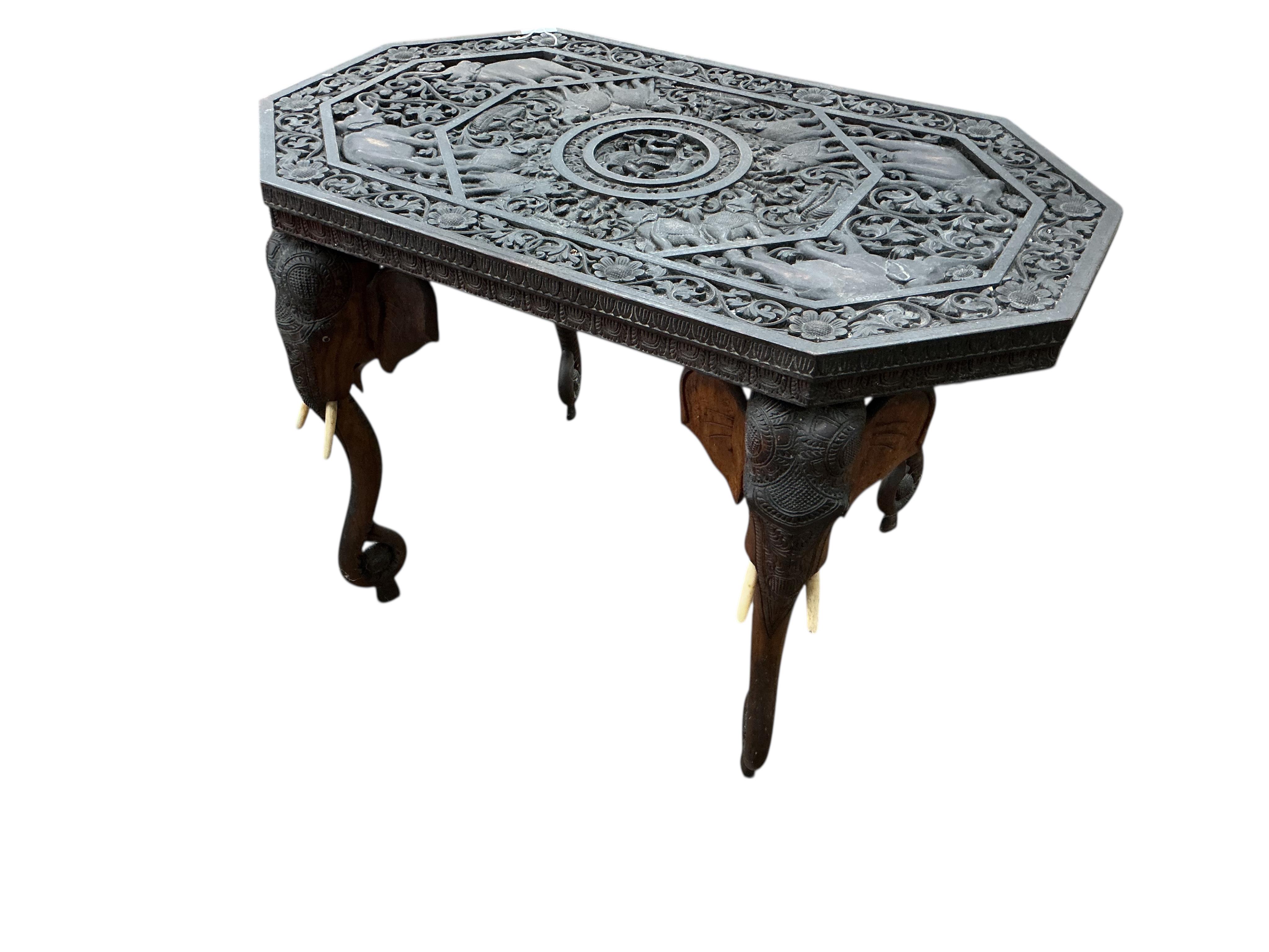An Indian octagonal carved hardwood occasional table, width 91cm, depth 54cm, height 61cm